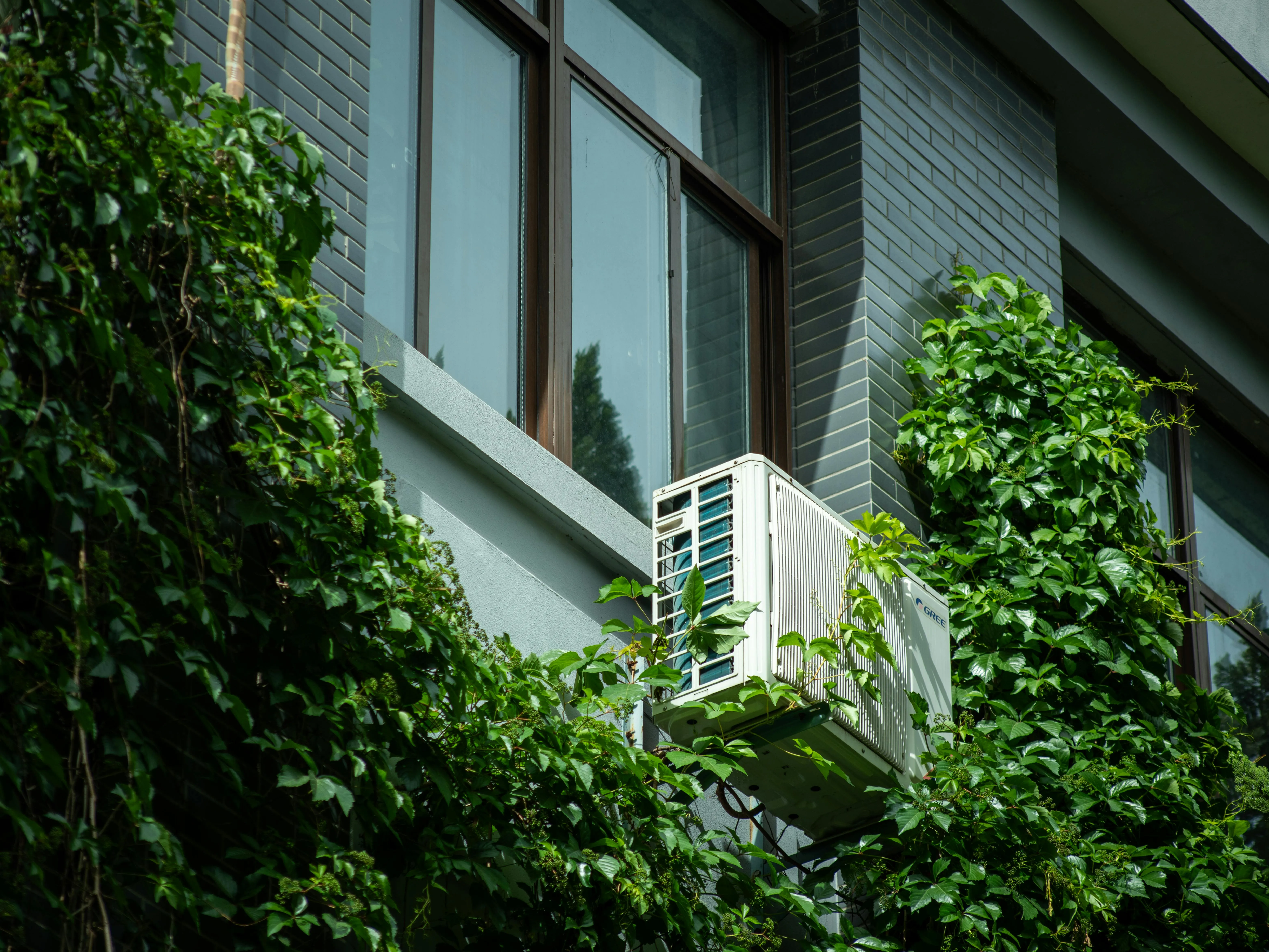 Modern building with an air-source heating unit mounted on the exterior — efficiency drives the payback period